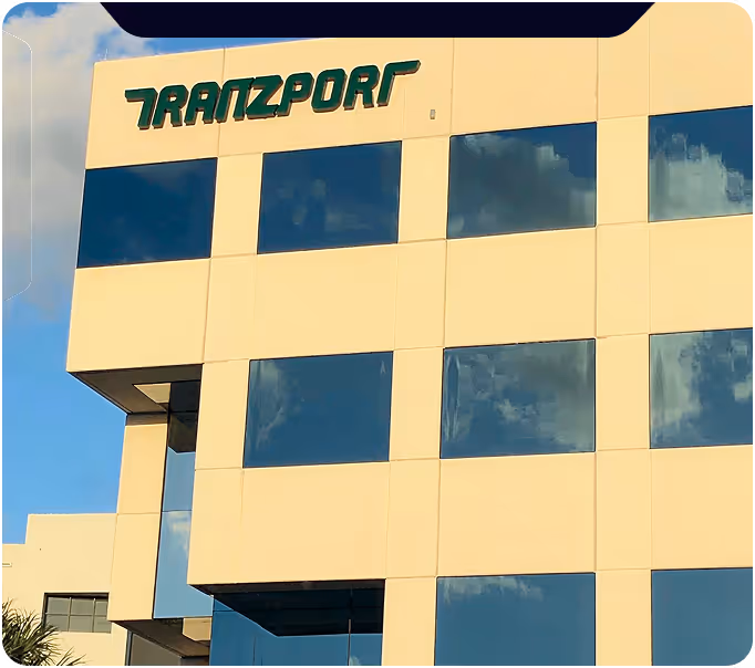 Dark abstract logistics graphic with green accent shapes, shown alongside the Tranzport contact form.